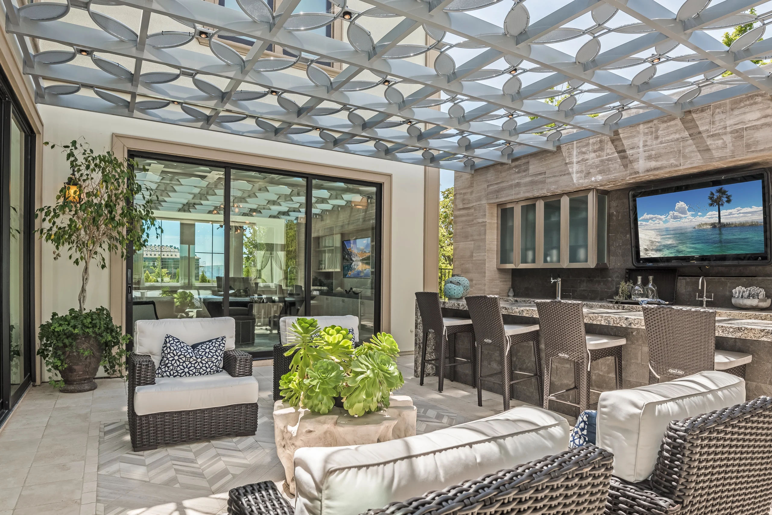 Outdoor kitchen with stone bar and herringbone tile patio
