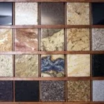 Assorted natural stone tile samples in various colors and textures.