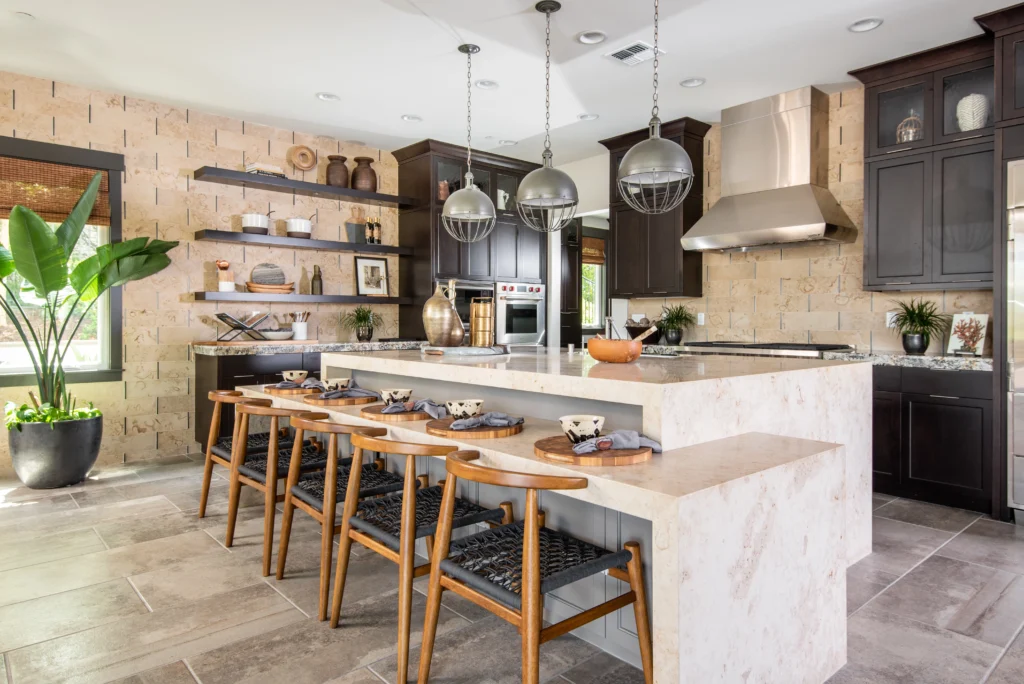 Modern kitchen with Hometown Stone solid surface island, stone tile backsplash, and designer flooring.
