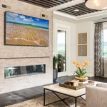 Contemporary living room with stacked stone fireplace wall and custom stone hearth by Hometown Stone.