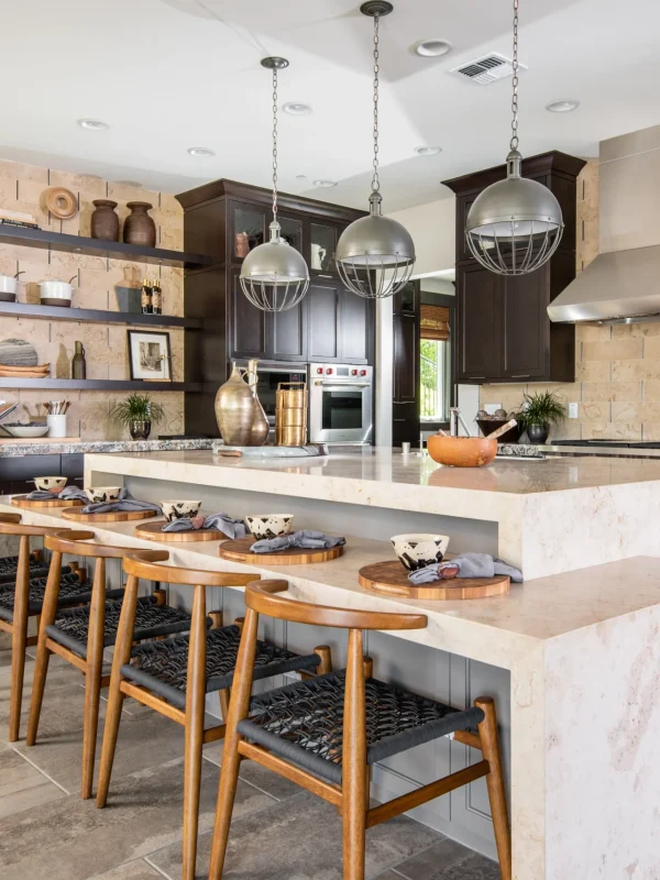 Modern kitchen with Hometown Stone solid surface island, stone tile backsplash, and designer flooring.